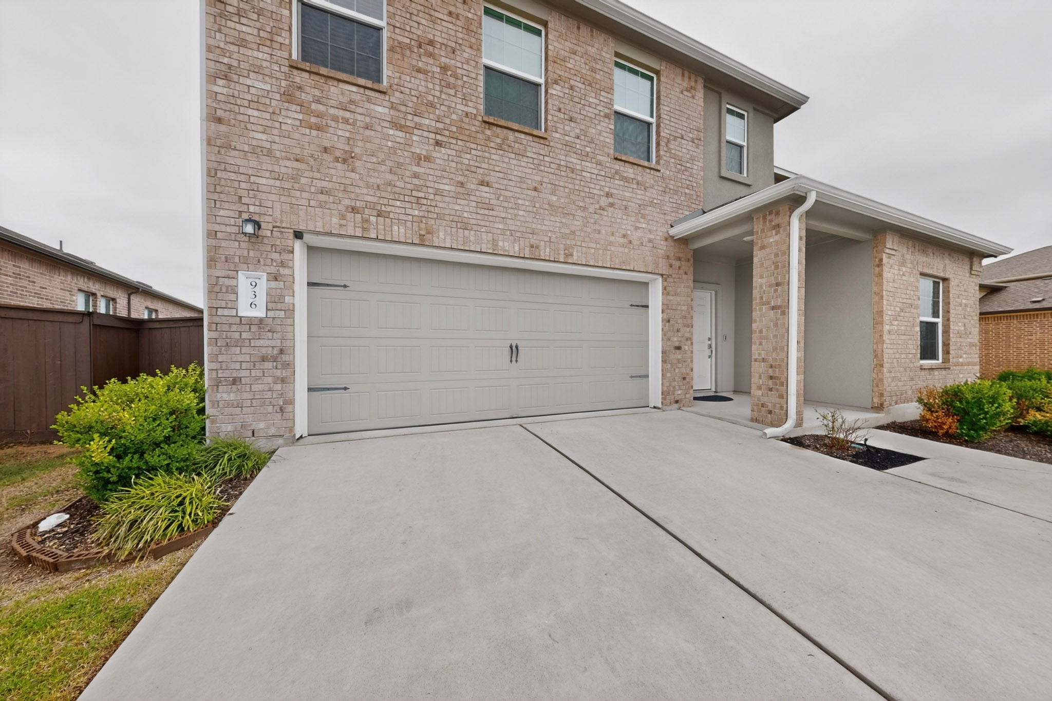 936 Mallow Road Leander, TX 78641 - Photo 3 of 16 Brick and stucco exterior with an attached garage, covered entry, and concrete driveway