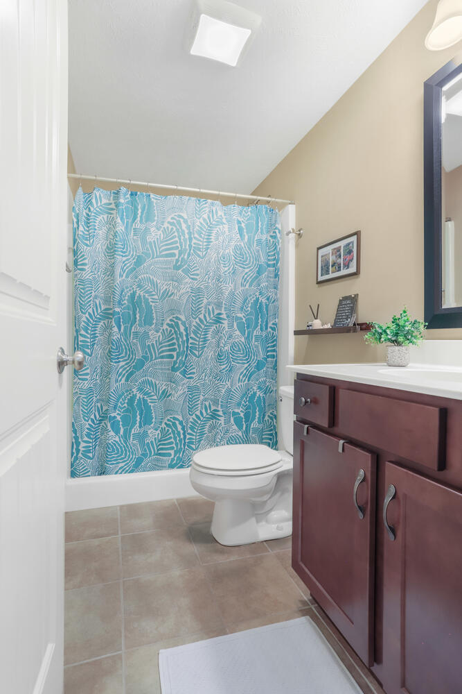 Undisclosed Address Savoy, IL 61874 - Photo 11 of 29 a bathroom with a sink a toilet and a mirror