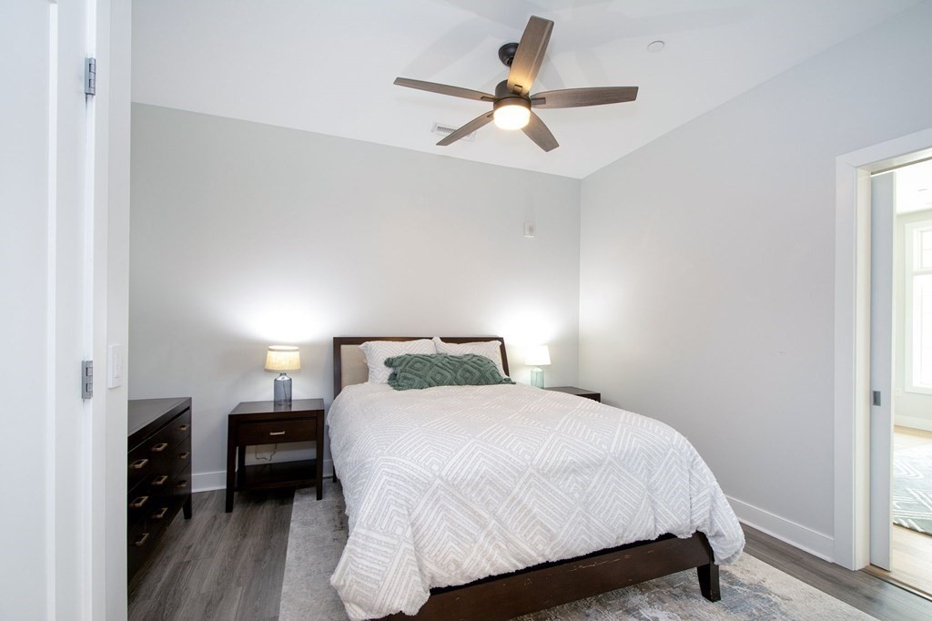 10 Shipyard Drive, Unit 102 Hingham, MA 02043 - Photo 13 of 31 a bedroom with a bed and a ceiling fan