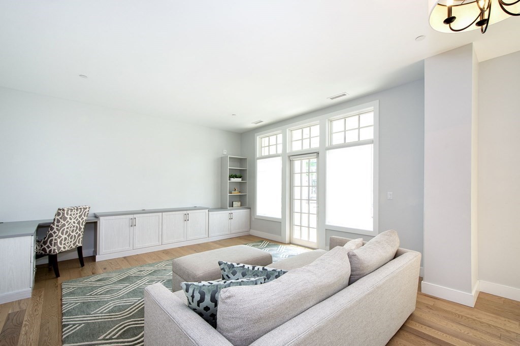 10 Shipyard Drive, Unit 102 Hingham, MA 02043 - Photo 15 of 31 a living room with furniture and a window