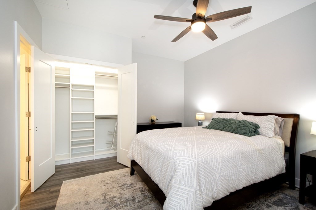 10 Shipyard Drive, Unit 102 Hingham, MA 02043 - Photo 17 of 31 a bedroom with a bed and a walk in closet