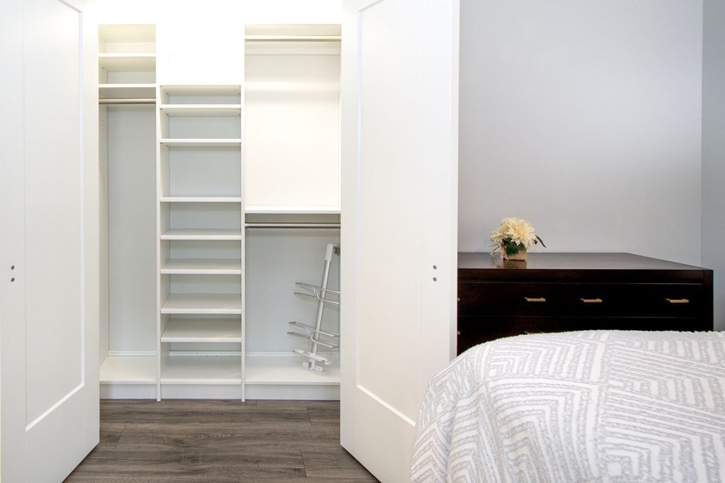 10 Shipyard Drive, Unit 102 Hingham, MA 02043 - Photo 18 of 31 a bedroom with a bed and a window