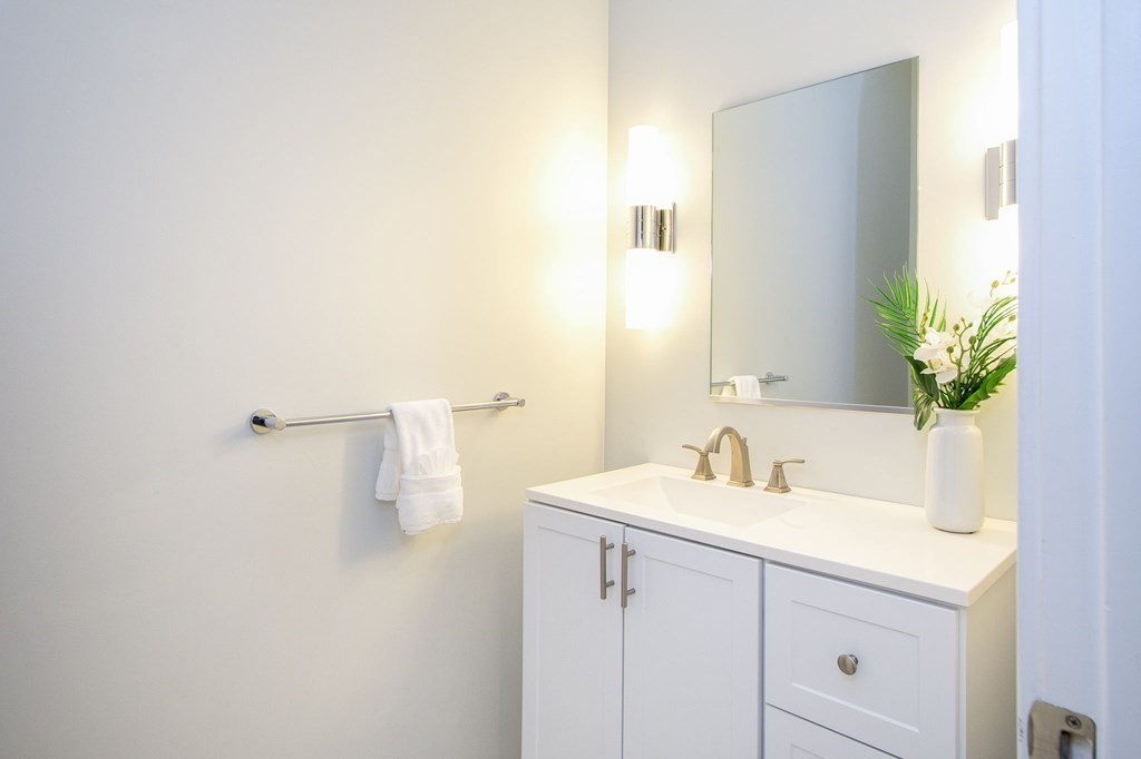 10 Shipyard Drive, Unit 102 Hingham, MA 02043 - Photo 20 of 31 a bathroom with a sink and a mirror