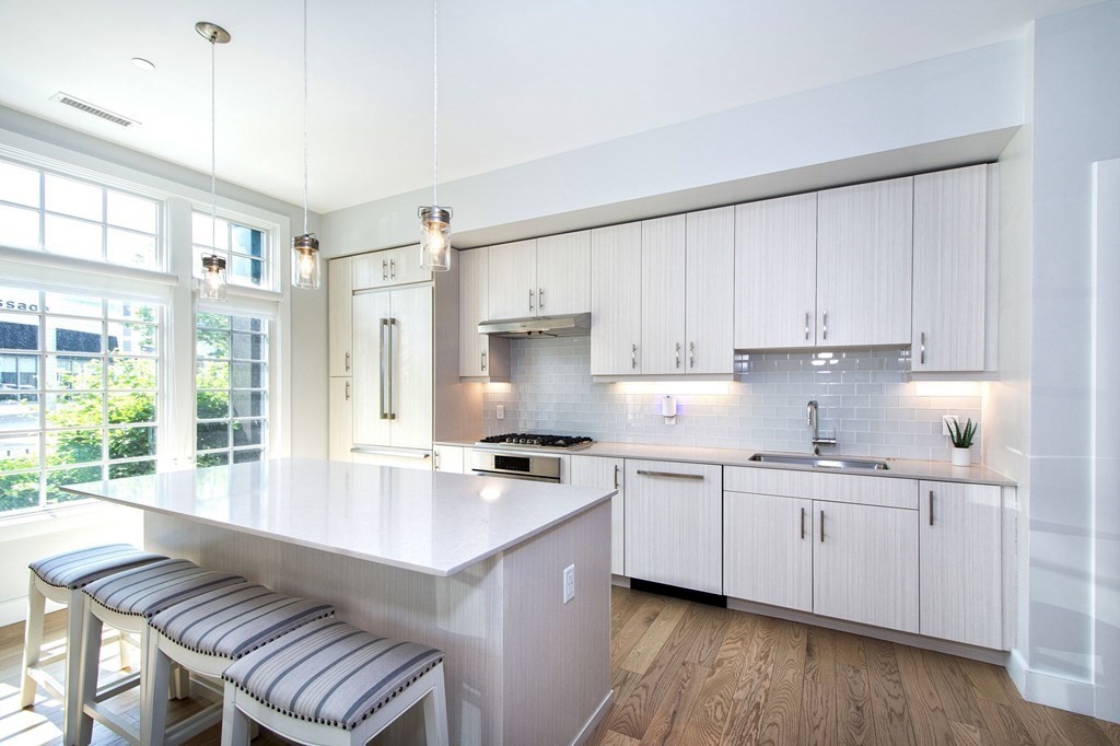 10 Shipyard Drive, Unit 102 Hingham, MA 02043 - Photo 3 of 31 a kitchen with a sink stove top oven and cabinets
