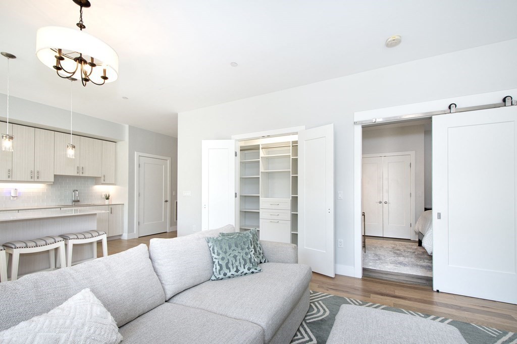 10 Shipyard Drive, Unit 102 Hingham, MA 02043 - Photo 10 of 31 a living room with furniture and a potted plant