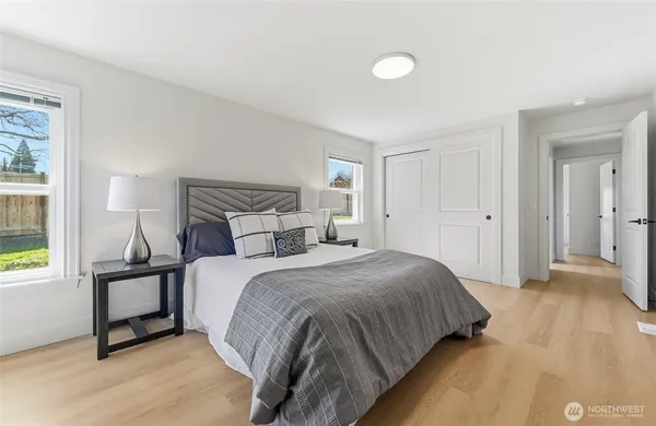 a bedroom with a bed and a window