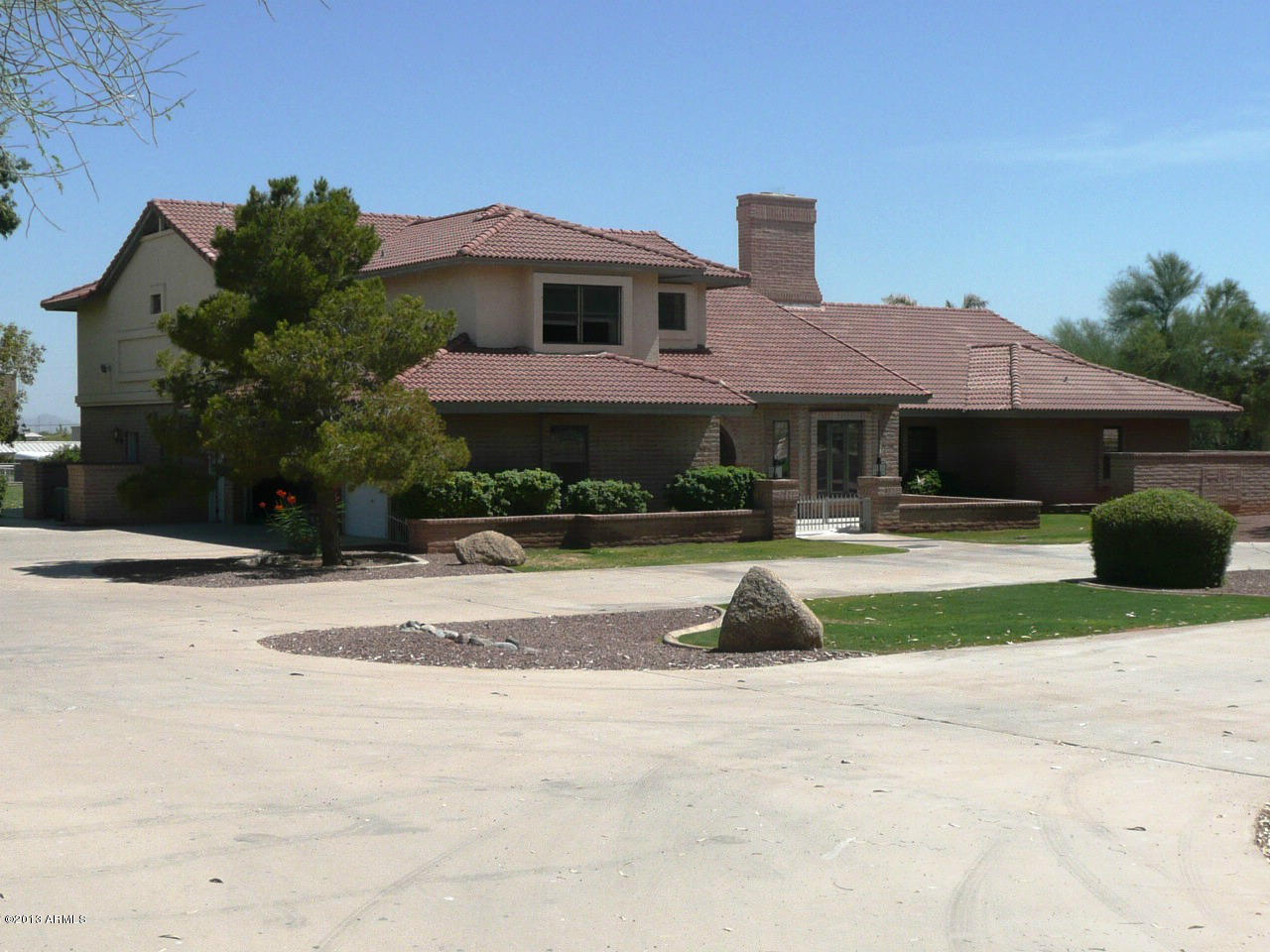 4128 West Elliot Road Laveen, AZ 85339 - Photo 2 of 114 a front view of a house with a yard