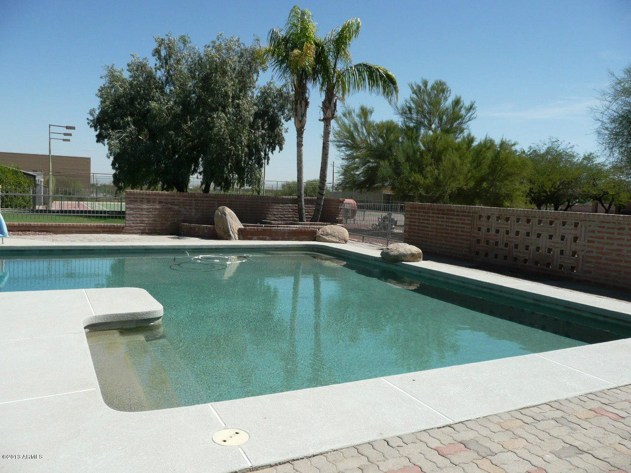 4128 West Elliot Road Laveen, AZ 85339 - Photo 21 of 114 a view of a swimming pool with a yard