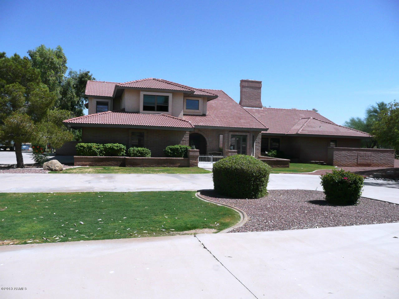 4128 West Elliot Road Laveen, AZ 85339 - Photo 3 of 114 a front view of a house with a yard