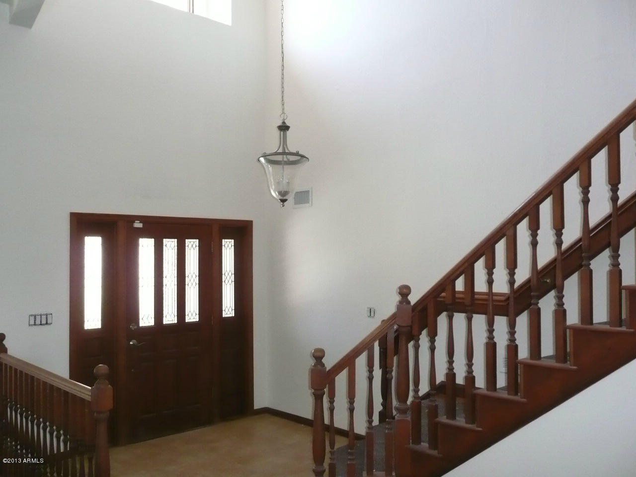 4128 West Elliot Road Laveen, AZ 85339 - Photo 34 of 114 a view of staircase with railing and a chandelier