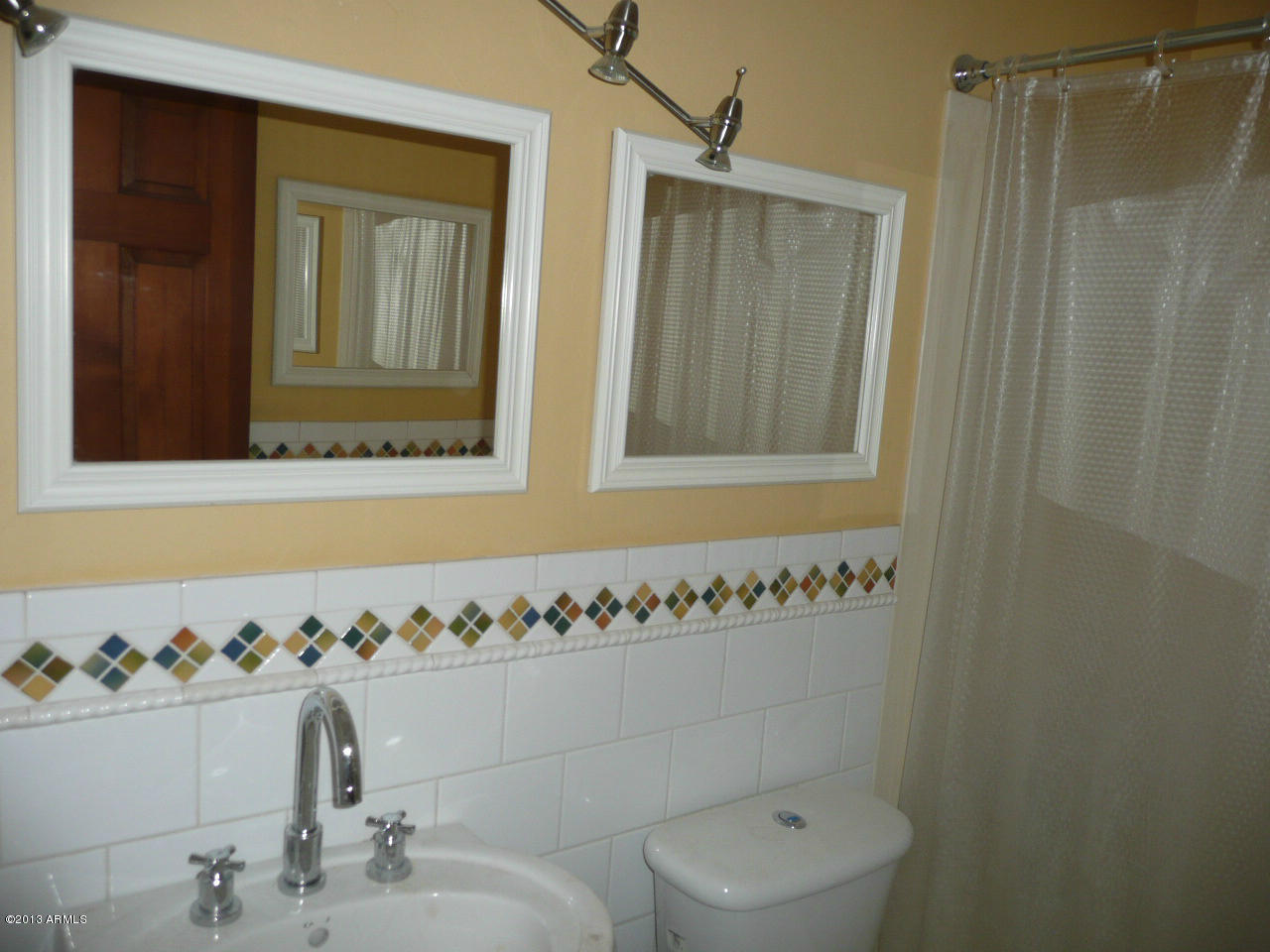 4128 West Elliot Road Laveen, AZ 85339 - Photo 37 of 114 a bathroom with a sink and a mirror