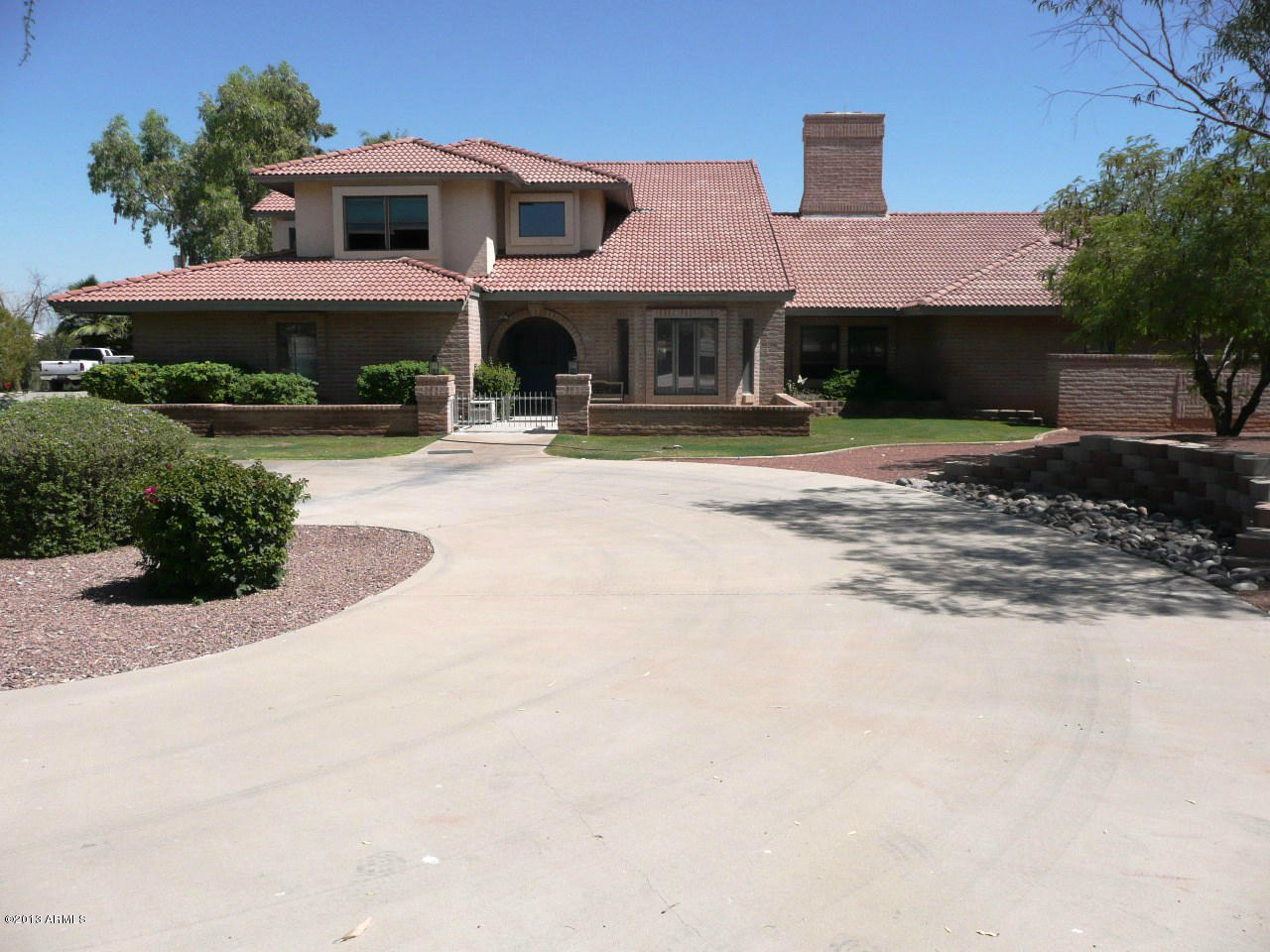 4128 West Elliot Road Laveen, AZ 85339 - Photo 4 of 114 a front view of a house with yard and green space