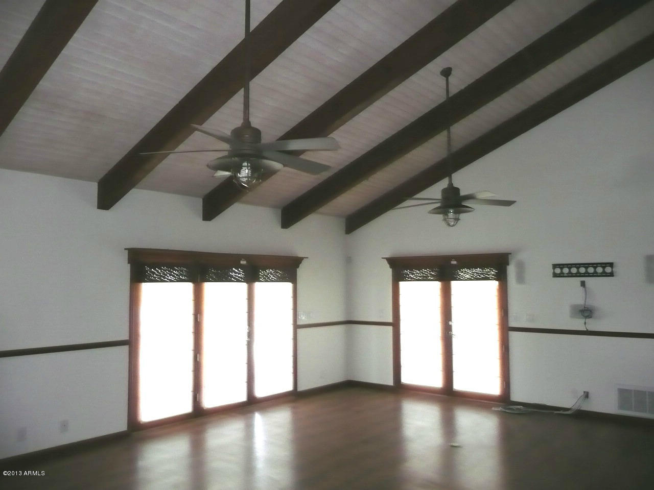 4128 West Elliot Road Laveen, AZ 85339 - Photo 44 of 114 a view of an empty room with wooden floor and a window