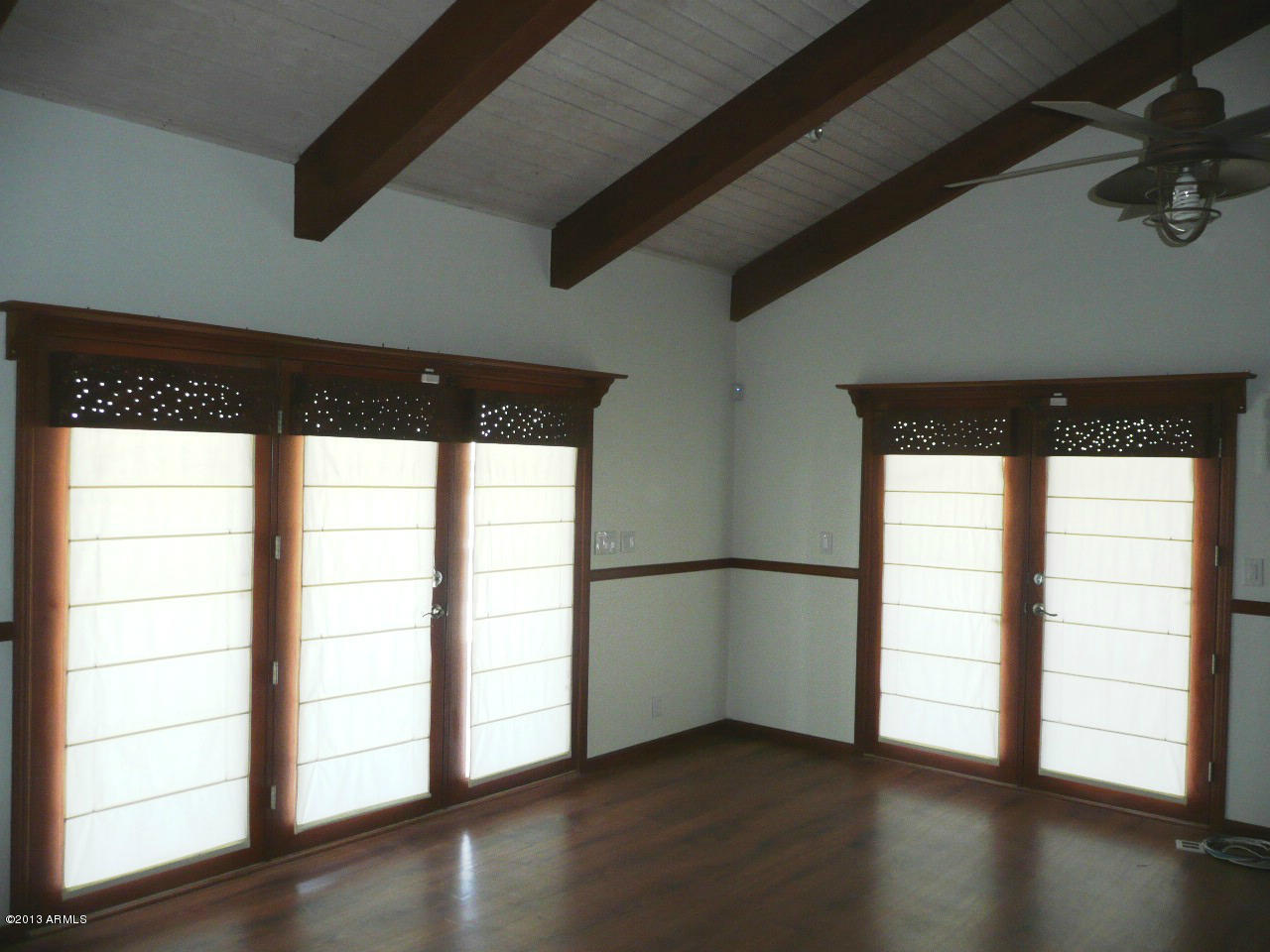 4128 West Elliot Road Laveen, AZ 85339 - Photo 45 of 114 an empty room with wooden floor and windows
