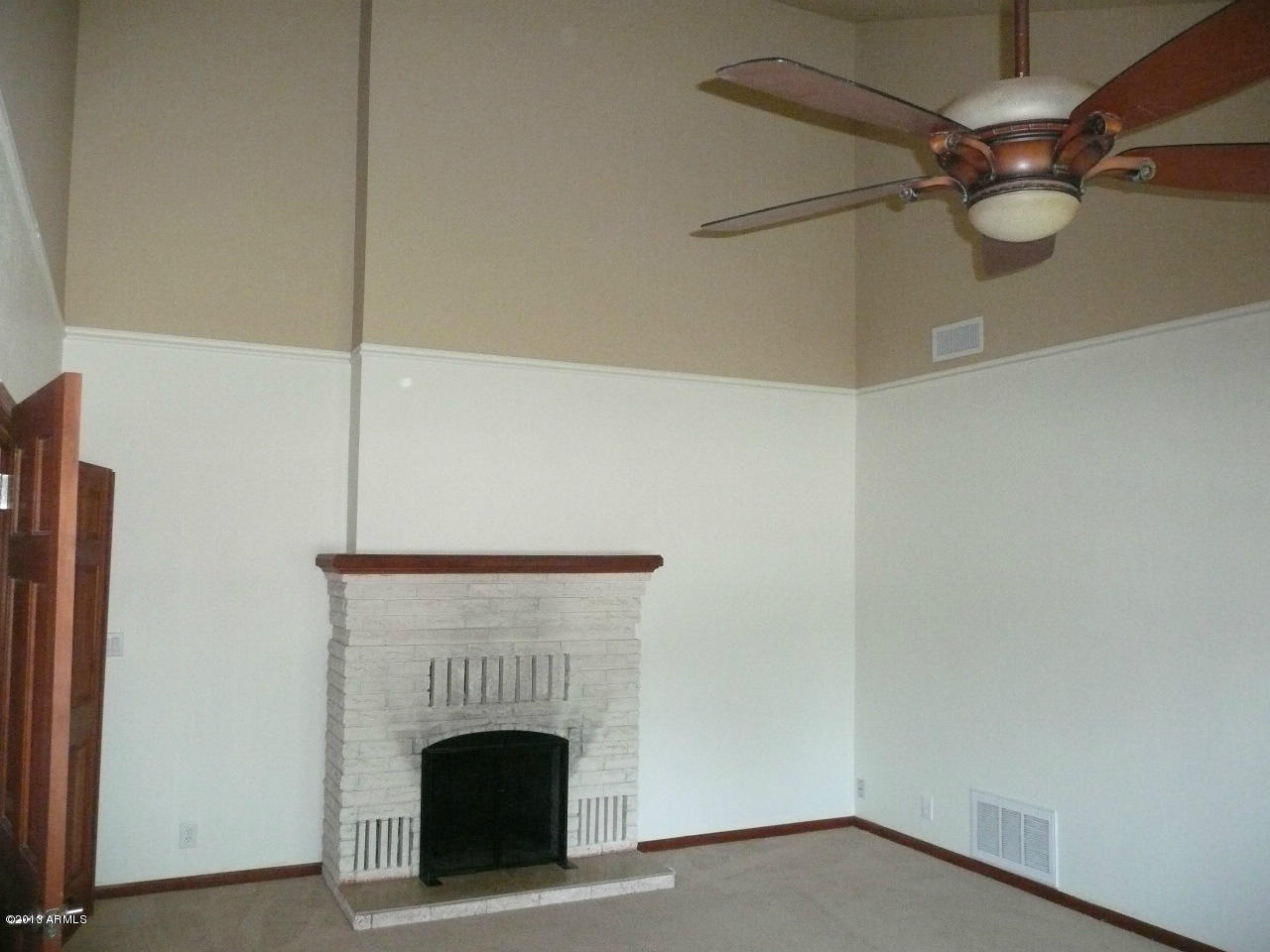 4128 West Elliot Road Laveen, AZ 85339 - Photo 57 of 114 a view of an empty room with a fireplace and a window