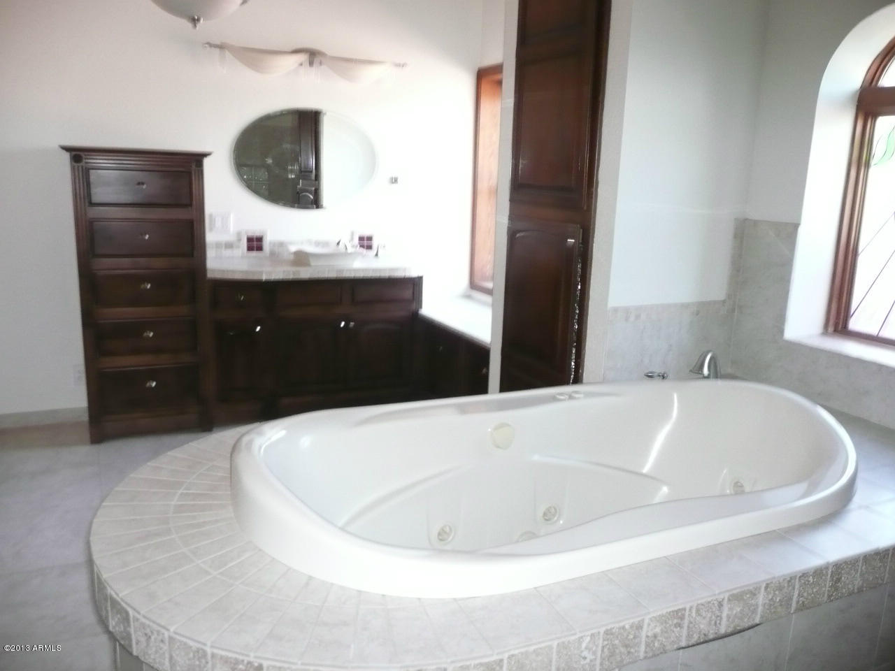 4128 West Elliot Road Laveen, AZ 85339 - Photo 59 of 114 a bath tub sitting in a bathroom and mirror