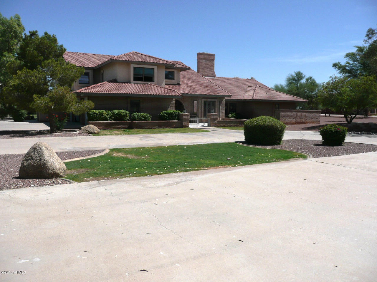 4128 West Elliot Road Laveen, AZ 85339 - Photo 6 of 114 a front view of house with yard and car parked