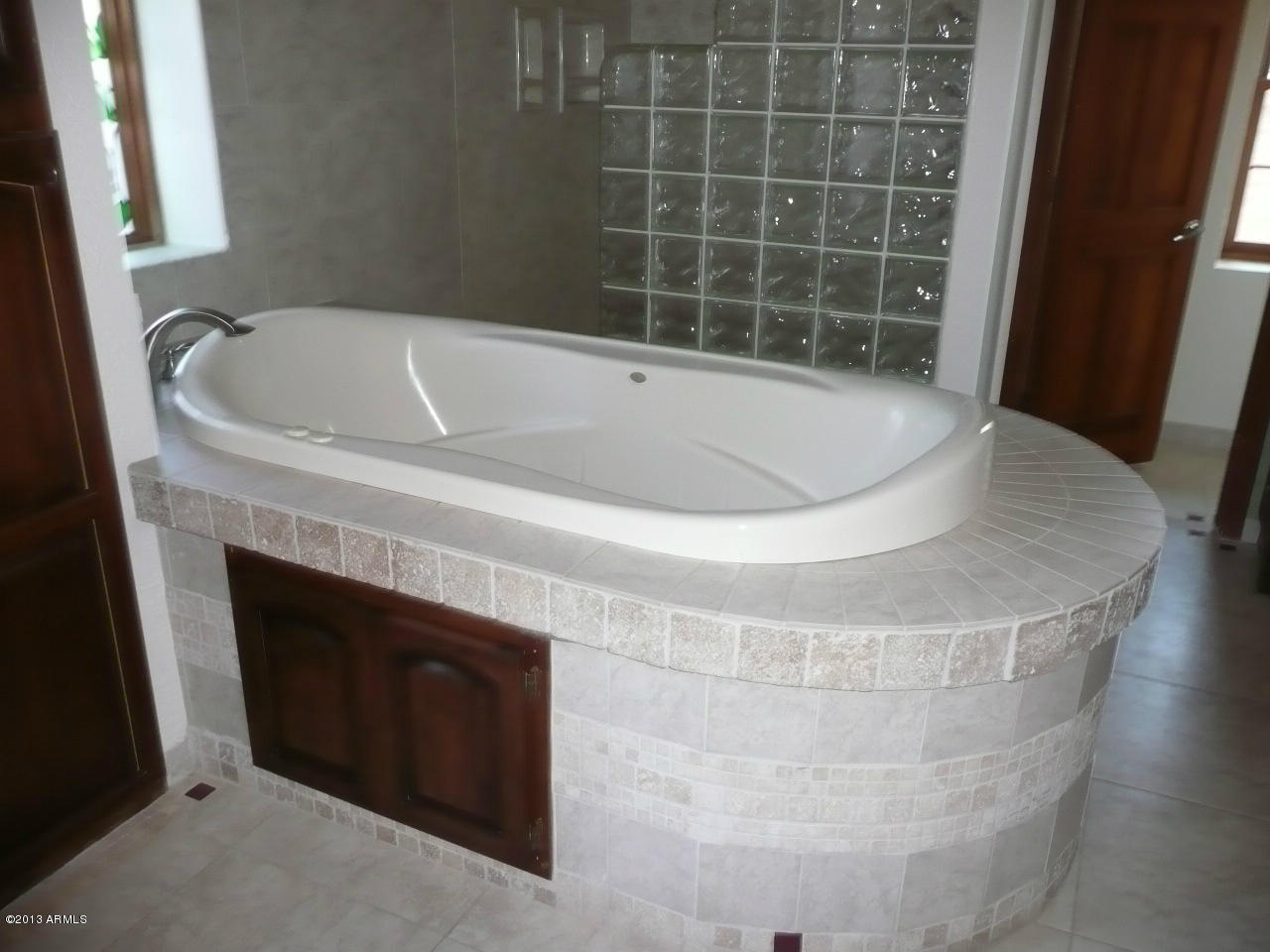 4128 West Elliot Road Laveen, AZ 85339 - Photo 61 of 114 a bath tub sitting in a bathroom next to a sink