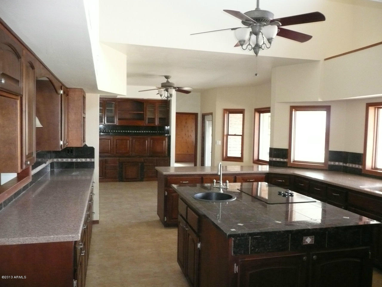 4128 West Elliot Road Laveen, AZ 85339 - Photo 64 of 114 a kitchen with stainless steel appliances granite countertop a sink and a stove