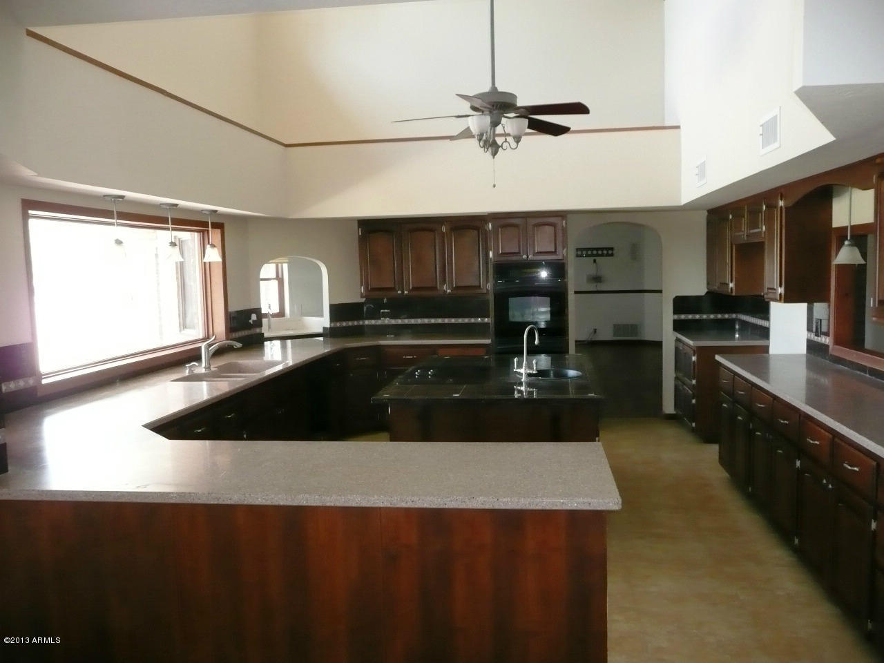 4128 West Elliot Road Laveen, AZ 85339 - Photo 68 of 114 a kitchen with kitchen island granite countertop a sink a counter top space and stainless steel appliances