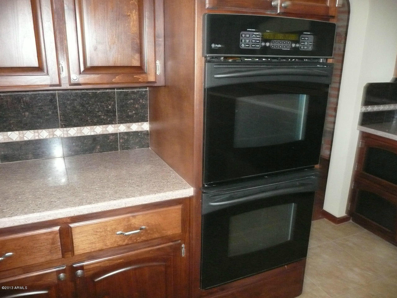 4128 West Elliot Road Laveen, AZ 85339 - Photo 71 of 114 a kitchen with granite countertop a stove and a microwave