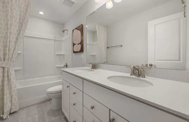 a bathroom with a granite countertop sink a toilet and a bathtub