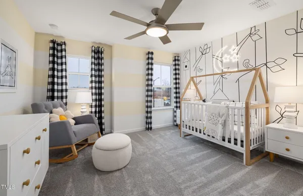 a bedroom with furniture and a large window