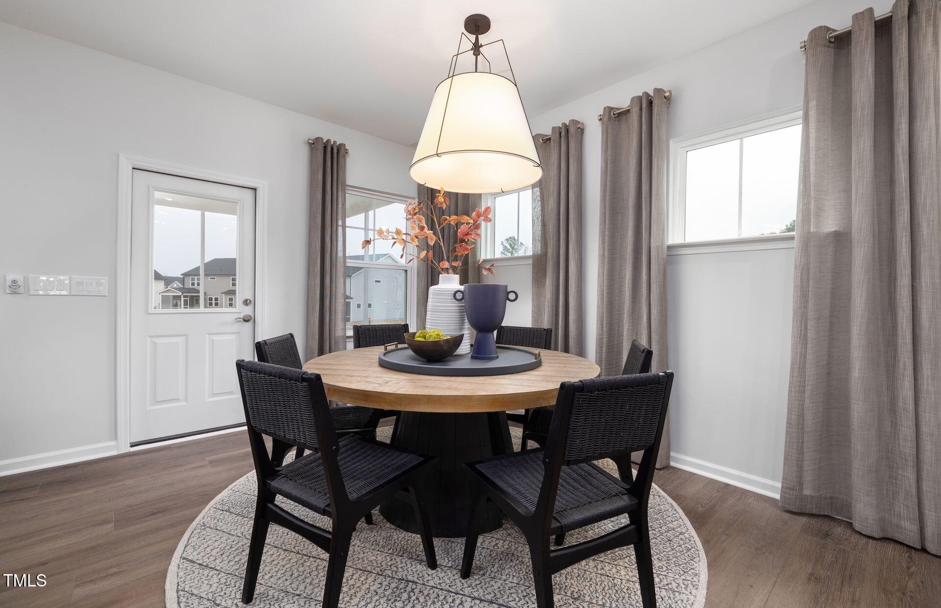 457 Grange Farm Place Raleigh, NC 27603 - Photo 4 of 30 a view of a dining room with furniture window and wooden floor