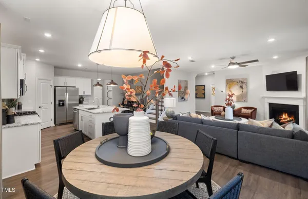 a living room with furniture a fireplace and a table