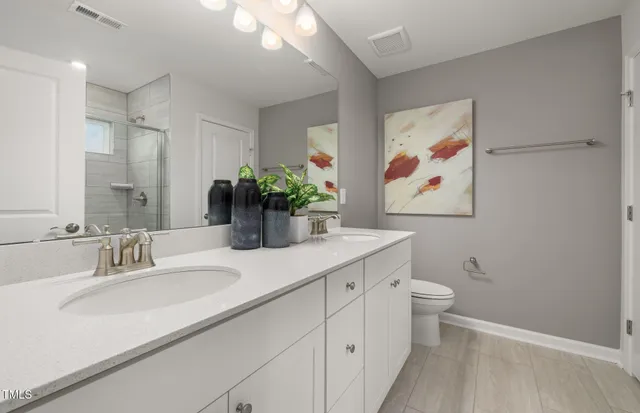 a bathroom with a sink a vanity and a large mirror