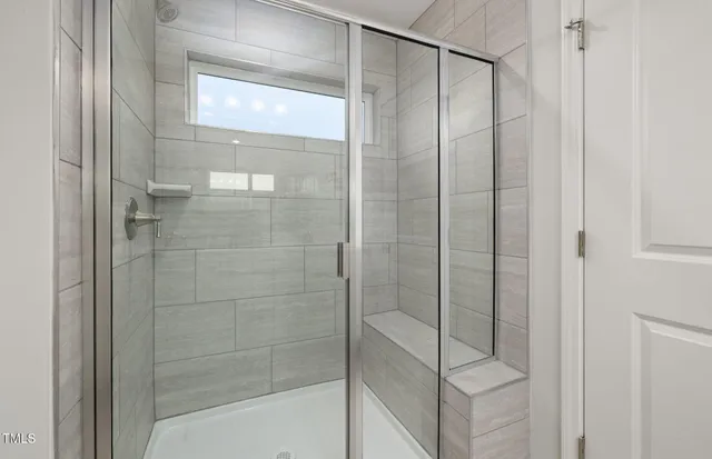 a bathroom with a glass shower door