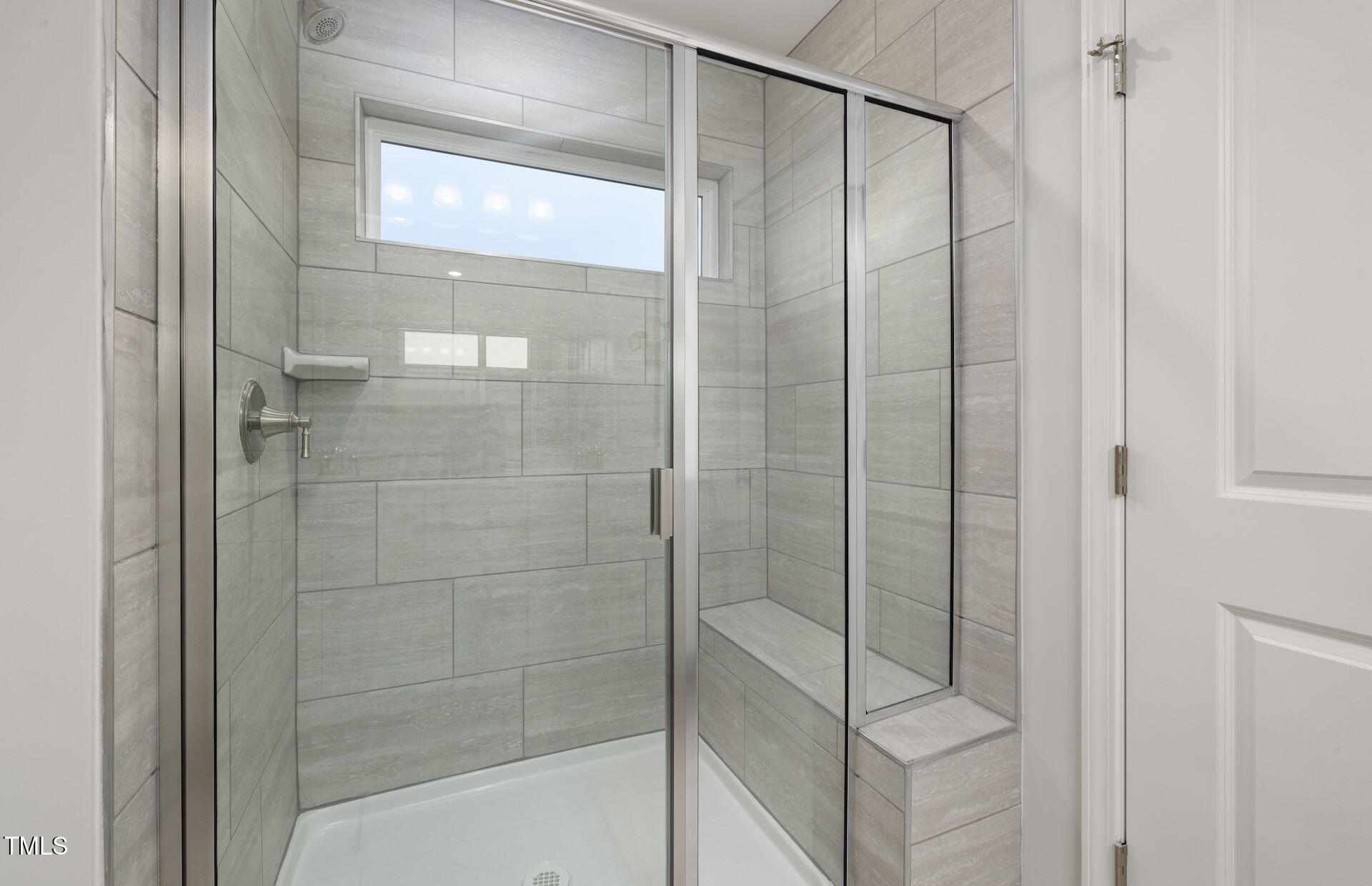 457 Grange Farm Place Raleigh, NC 27603 - Photo 10 of 30 a bathroom with a glass shower door