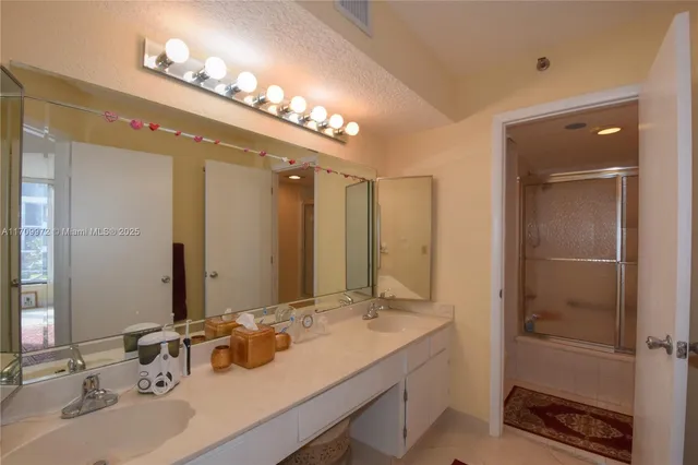 a bathroom with a double vanity sink and a mirror