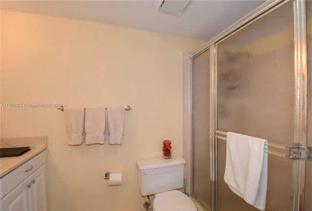 a bathroom with a sink a mirror and a shower