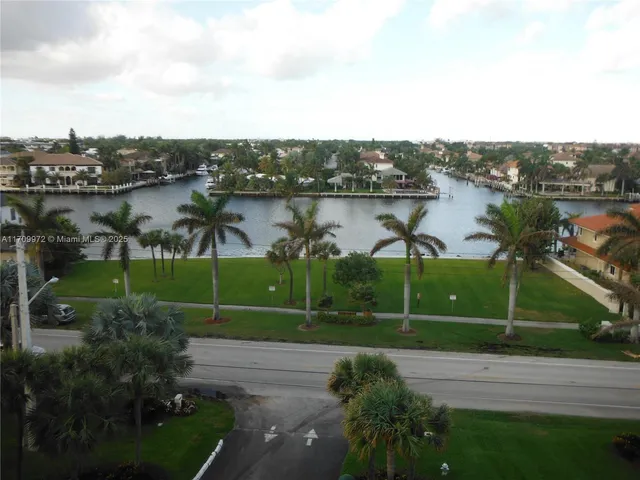 a sign on the side of the green field