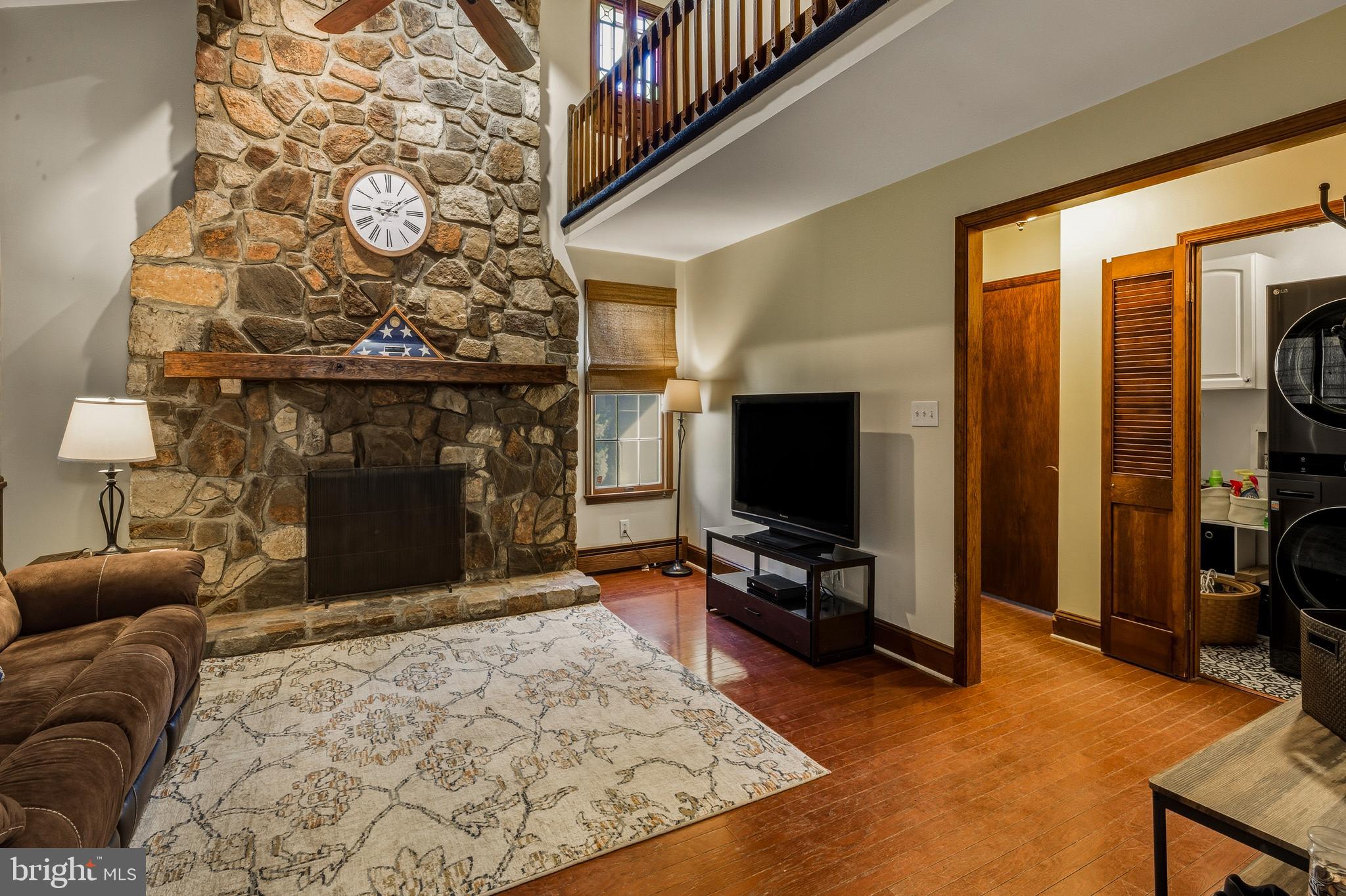 335 2nd Avenue Lindenwold, NJ 08021 - Photo 11 of 32 a living room with furniture a flat screen tv and a fireplace