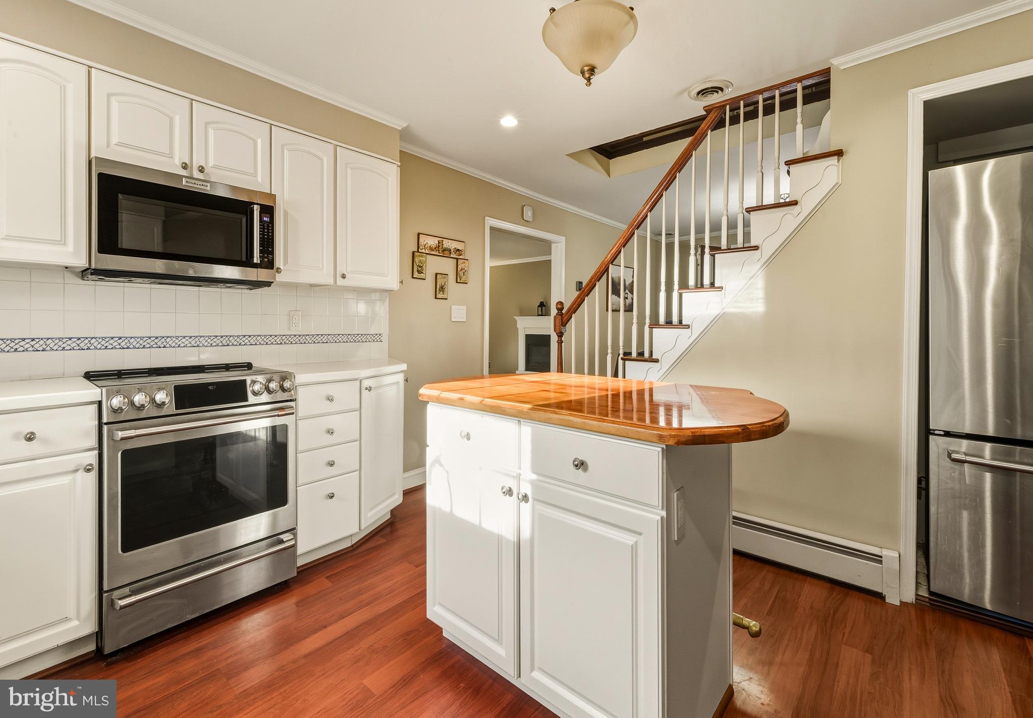 335 2nd Avenue Lindenwold, NJ 08021 - Photo 16 of 32 a kitchen with stainless steel appliances a stove microwave and a refrigerator
