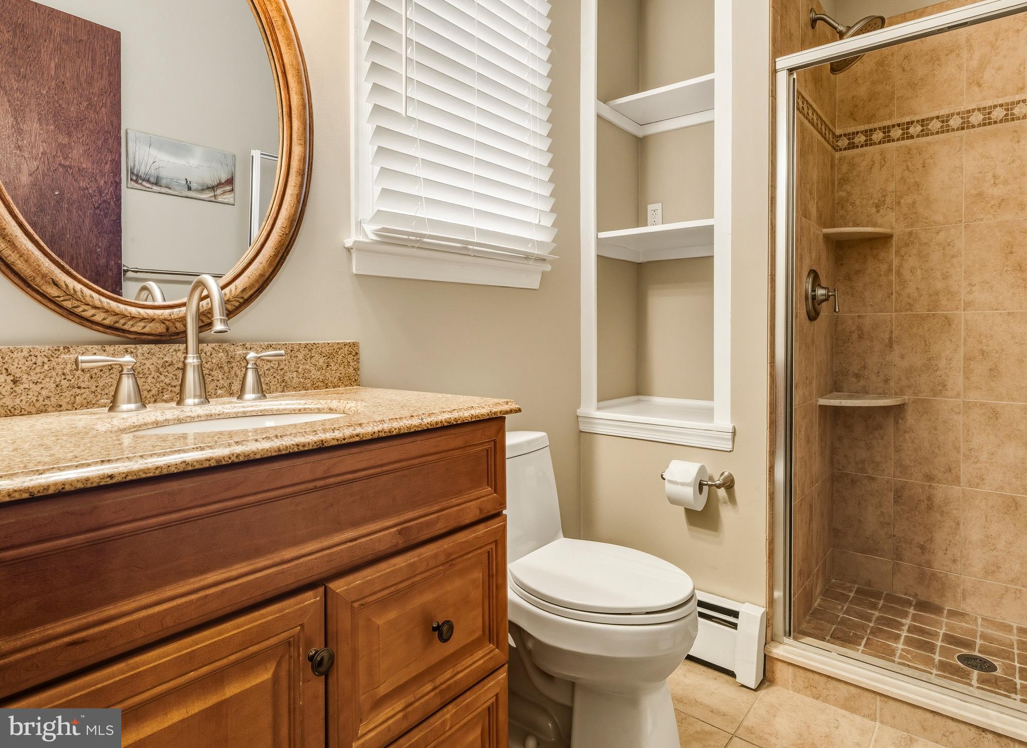 335 2nd Avenue Lindenwold, NJ 08021 - Photo 21 of 32 a bathroom with a sink a toilet and a mirror
