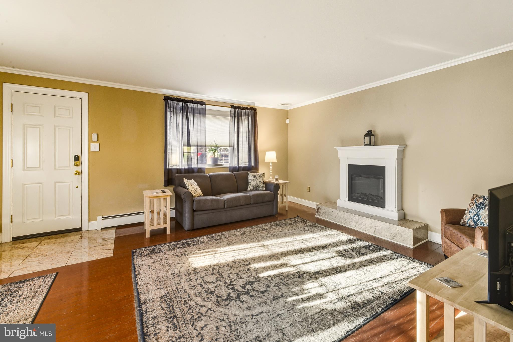 335 2nd Avenue Lindenwold, NJ 08021 - Photo 3 of 32 a living room with furniture and a fireplace