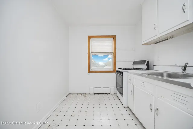 a bathroom with a sink a vanity and a window
