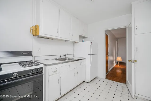 a kitchen with stainless steel appliances a sink stove and cabinets