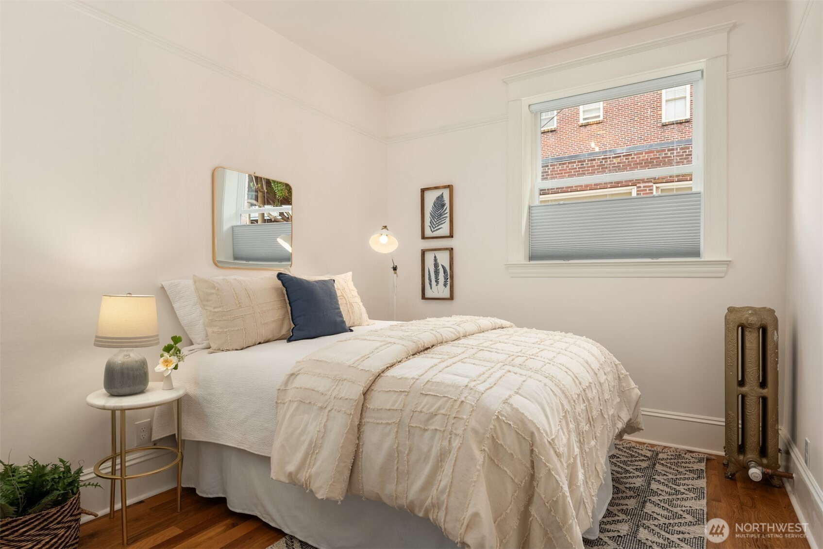 1726 15th Avenue, Unit 7 Seattle, WA 98122 - Photo 15 of 24 a bedroom with a bed and wooden floor