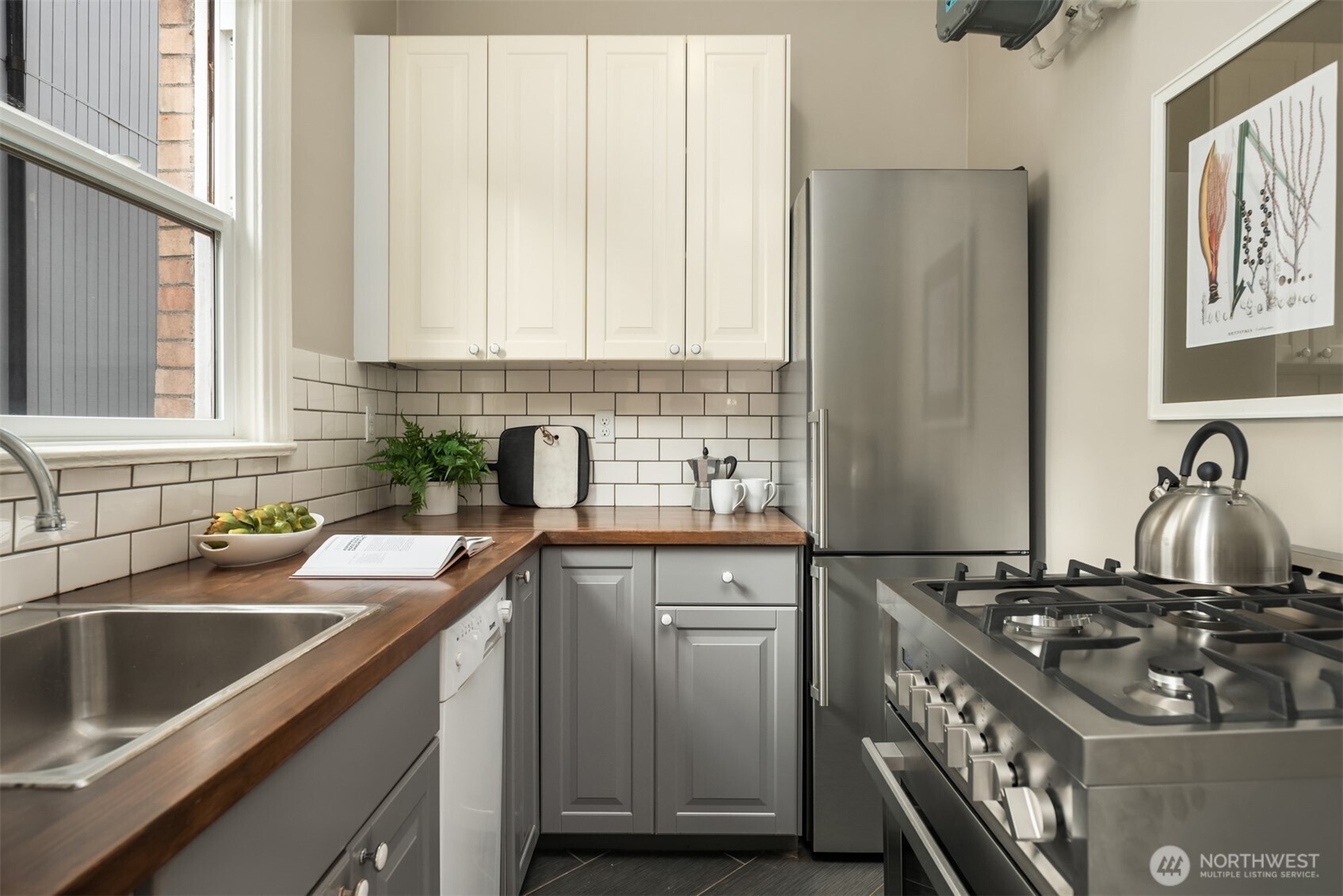 1726 15th Avenue, Unit 7 Seattle, WA 98122 - Photo 10 of 24 a kitchen with a sink stove top oven and cabinets