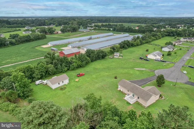 an aerial view of a house with yard