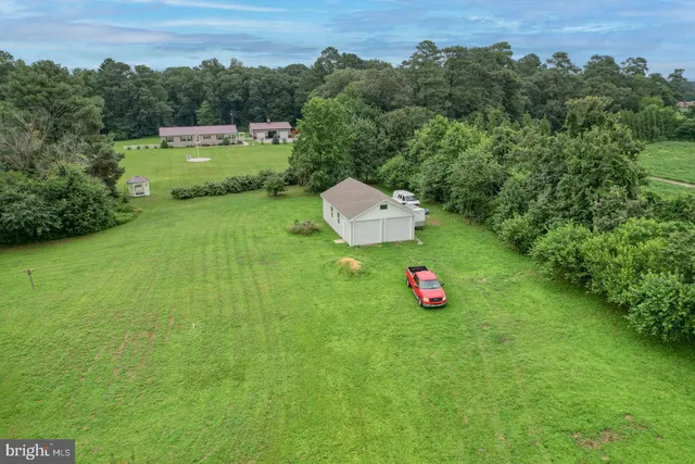 a view of a back yard of the house with a yard