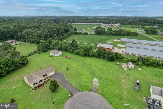an aerial view of a house with yard