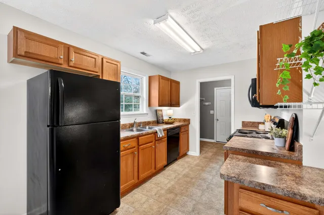 a kitchen with stainless steel appliances granite countertop a sink stove and cabinets