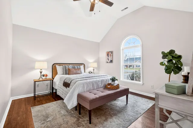 a bedroom with a bed and a potted plant