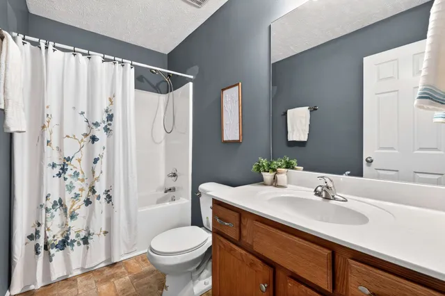 a view of a swimming pool with a yard and palm trees