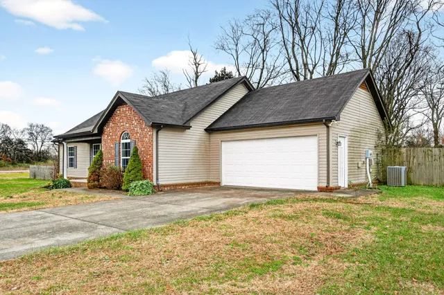 a view of a house with a yard and garage